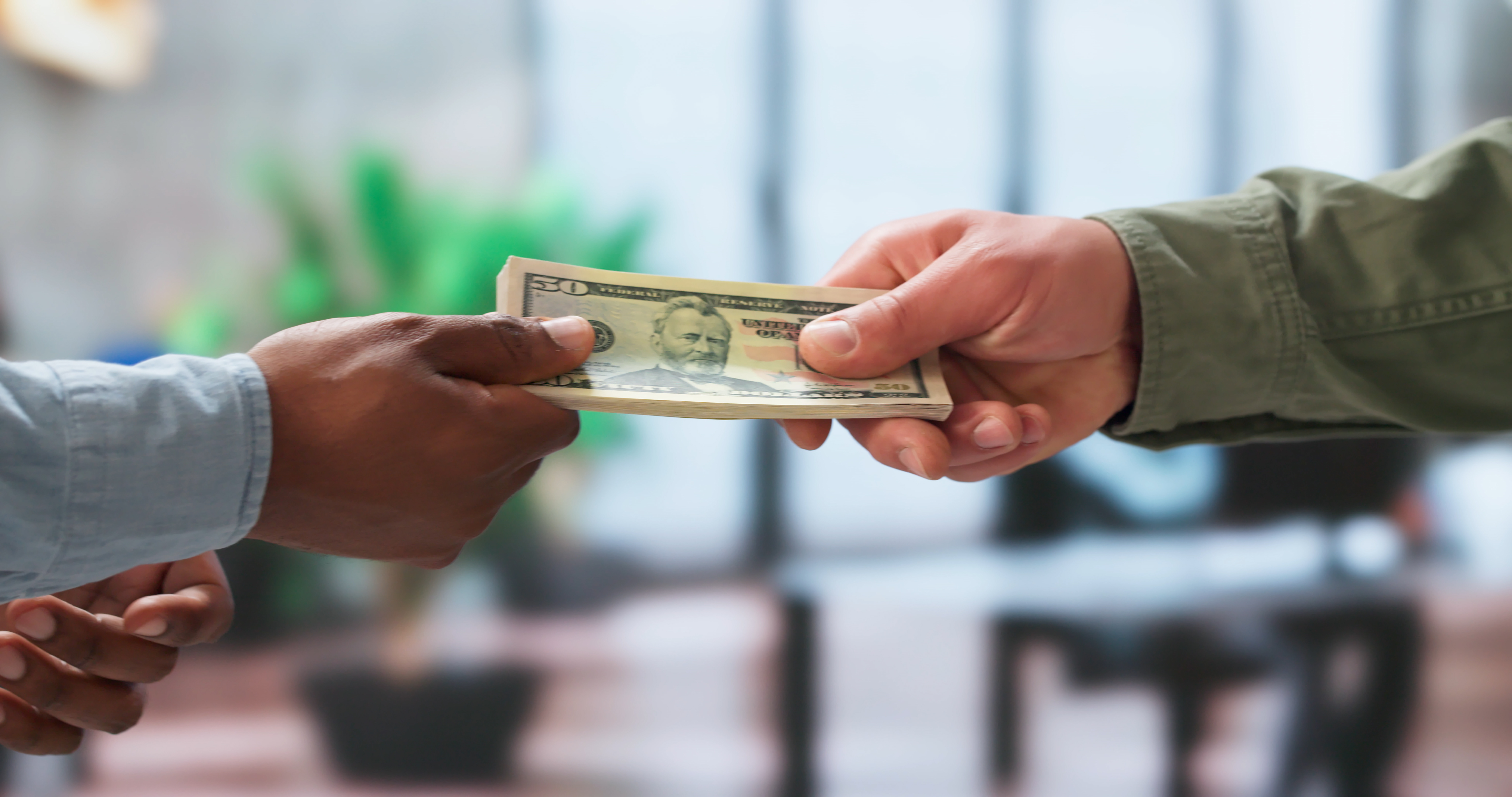 Young Man Gives Cash Payment To Delivery Courier For Quick Service.